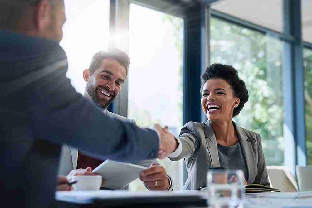 Two people shaking hands after joining NOVUS Crystal Glass franchise network